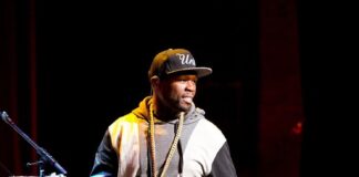 Rapper 50 Cent performs during the 4th Annual "Home For The Holidays" Benefit Concert at Beacon Theatre on December 6, 2014 in New York City