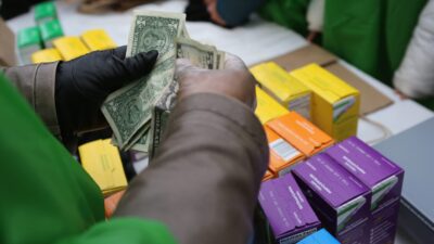 NEW YORK, NY - FEBRUARY 08: MOney is collected as Girl Scouts sell cookies while a winter storm moves in on February 8, 2013 in New York City. The scouts did brisk business, setting up shop in locations around Midtown Manhattan on National Girl Scout Cookie Day. (Photo by John Moore/Getty Images)
