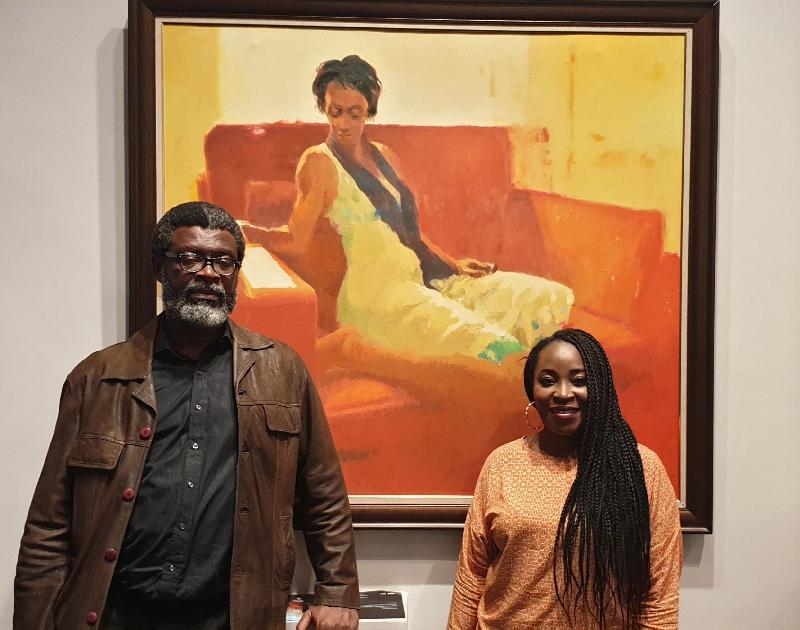 TAYO - Painter Segun Adejumo and Jade Art studios' curator Ronke Bolanle in front of Segun's painting titled MORENIKE'S LETTER at the Gallery