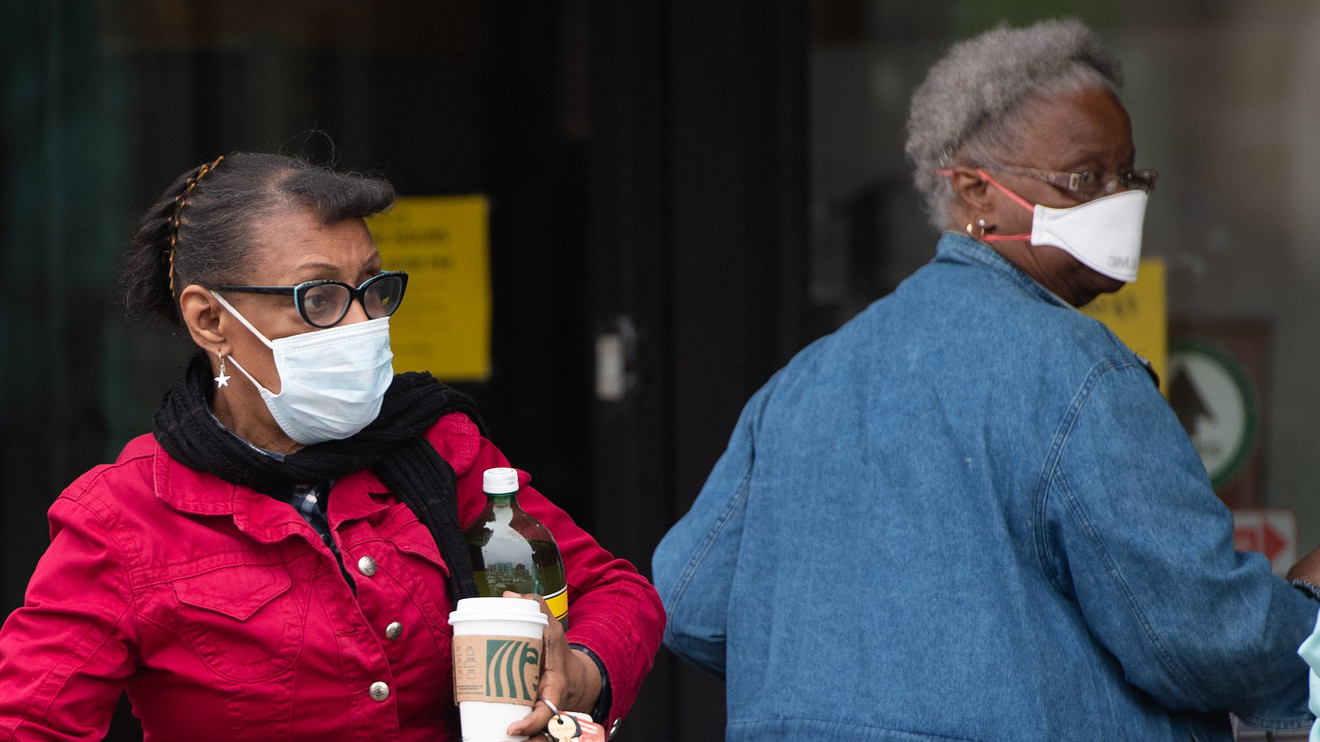 Women wearing masks leave a supermarket in Washington, D.C., on Tuesday. Getty Images
