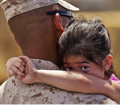 Military vet holds a child canva