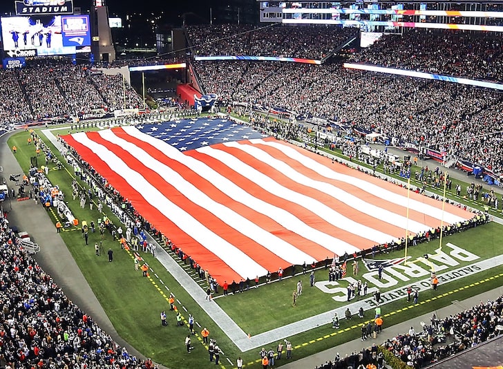 American flag across stadium field