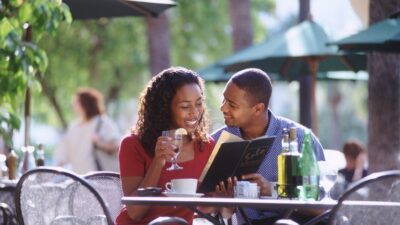 Black couple dining outside - iStock