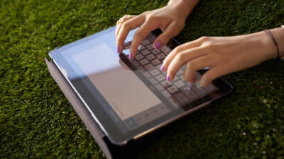writing - woman-emailing-and-texting-with-tablet-computer-on-grass (yay images)