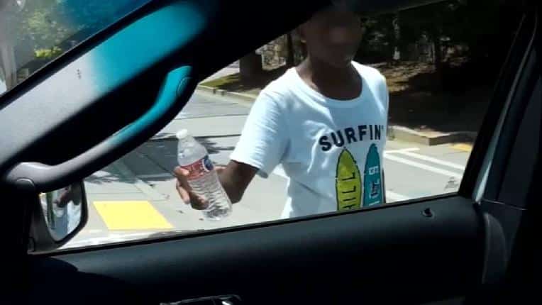 Boy selling water on the street - Atlanta