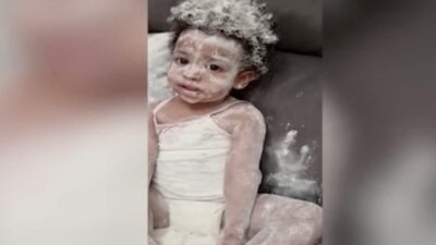 Toddler covered in flour