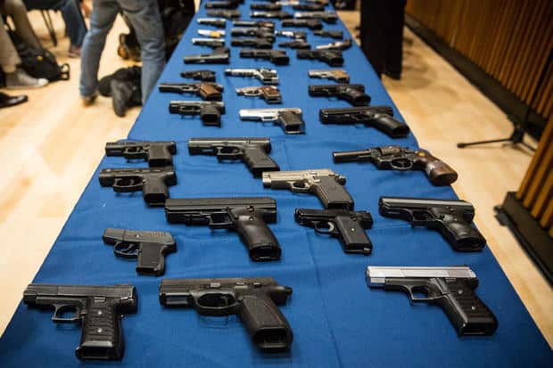 Guns (pistols on table) - Gettyimages-176922005