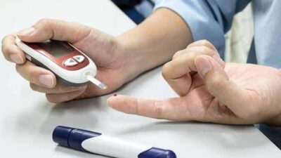 person testing blood sugar
