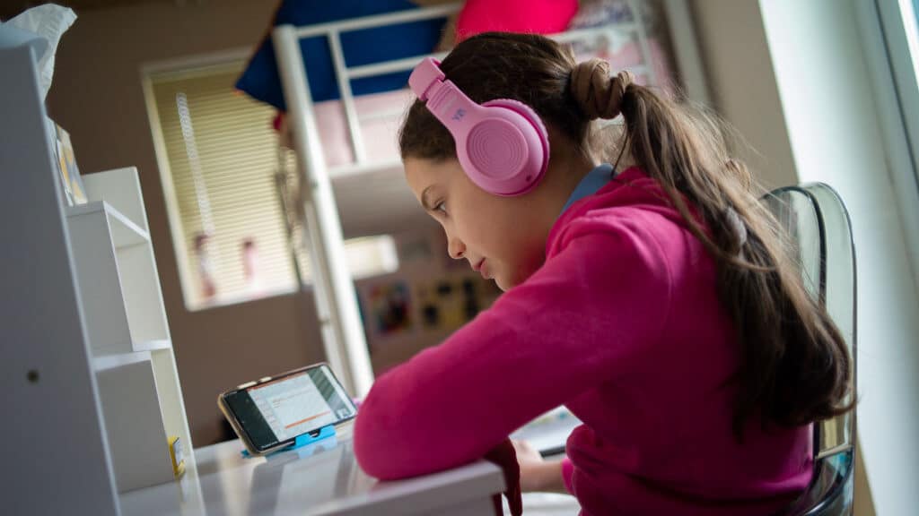 Girl with headphones on - GettyImages-1299123569-e1635510518774