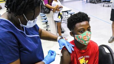 African American - Black boy getting COVID shot - Gettyimages