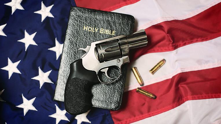Christians and Guns American flag Bible revolver bulletts - Getty