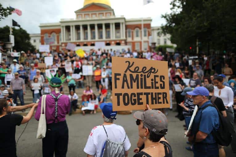 Demonstrators gather outside the Massachusetts State House in Boston to protest the Trump administration policy of separating children from their parents 