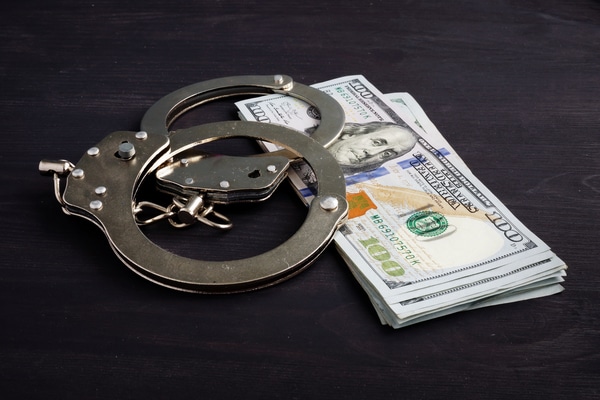 Bail - handcuffs-and-money-dollars-for-bail-bonds