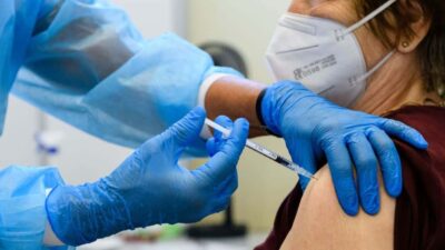 Woman getting COVID-19 jab