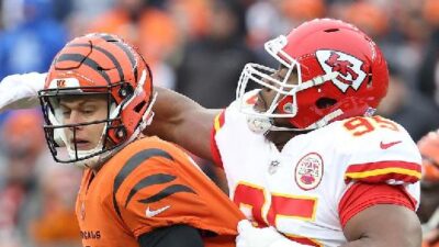 Joe Burrow (Cincinnati QB) eludes Kansas City defender - Getty