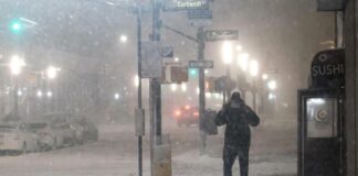 Man in snowstorn in Lower Manhattan - Getty