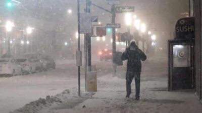 Man in snowstorn in Lower Manhattan - Getty