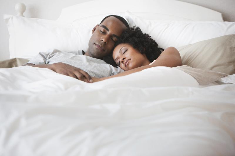 Black couple sleeping - GettyImages