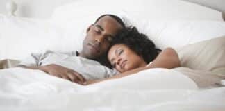 Black couple sleeping - GettyImages