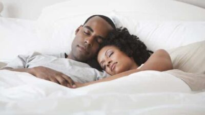 Black couple sleeping - GettyImages