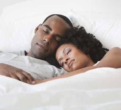 Black couple sleeping - GettyImages