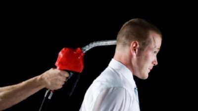 Gas pump - Man with Gas Nozzle (gun) -trigger to head