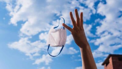 End of the fight against the pandemic, launching protection mask through the air and enjoying the fresh air