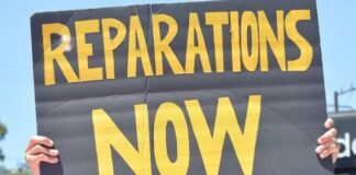 Reparations Now (sign) - Getty