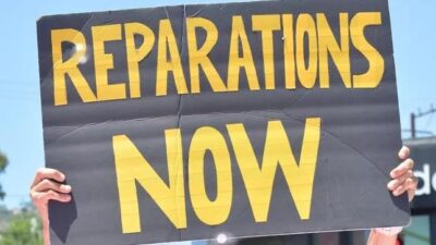 Reparations Now (sign) - Getty