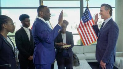 Toks Omishakin being sworn in by Gov. Gavin Newsom Feb 28, 2022 (Facebook)