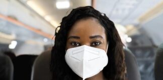 Woman Wearing Mask on Plane (Getty)