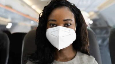 Woman Wearing Mask on Plane (Getty)