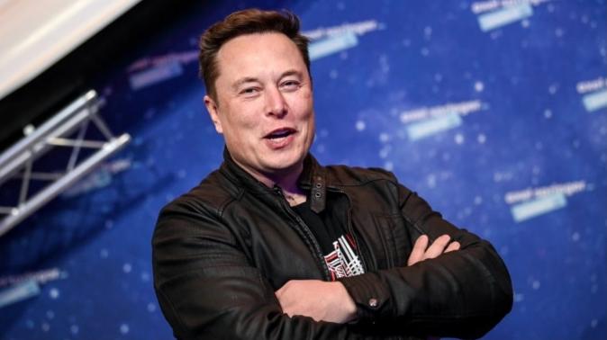 Elon Musk (arms crossed) - Getty