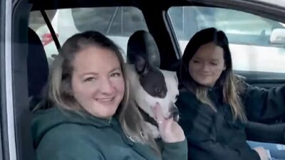 Bella and couple who adopted her