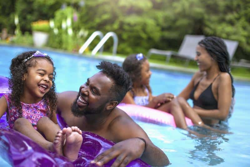 Black Family in pool - GettyImages
