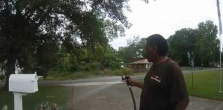 black man watering garden