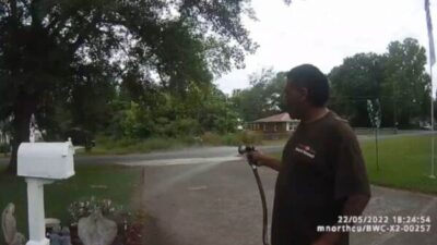 black man watering garden