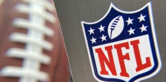 The NFL logo is seen on a football / Getty