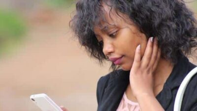 Young woman searching phone for online love opportunity - PxHere