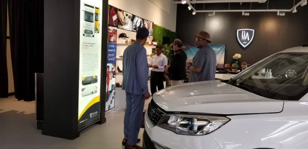 The CEO of Derek Automotive talks to customers as they browse their electric vehicle showroom.  (photo credit: jeffcars.com)