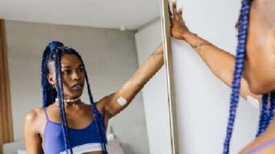 Black Woman Looking At Herself in Mirror