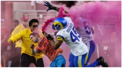 man rushes football field