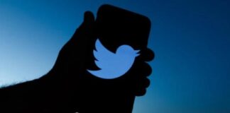 Twitter - hand witrh twitter logo on smartphone - Getty