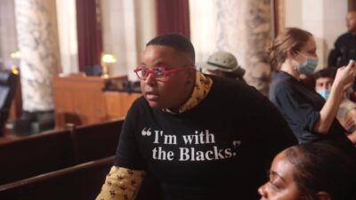 Dr. Diandra “Dee” Bremond member of the Black Los Angeles Young Black Democrats wears shirt I’m with the Blacks at October 6, 2022 city council meeting.