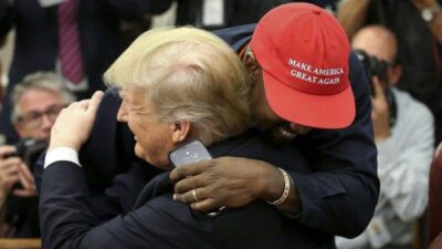 Donald Trump gets hugged by KanYe West (Getty)