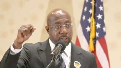 Raphael Warnock (fist) - Getty