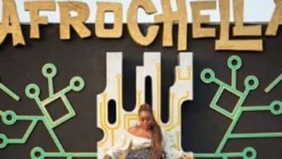 2022 Afrochella - female sitting on logo chair