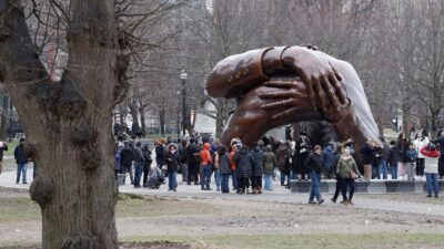 The Embrace Sculpture and crowds (John Lamparski-NurPhoto via AP)