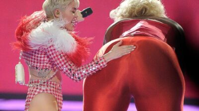 Miley Cyrus spanks BIG Butt (David Becker-Getty Images)