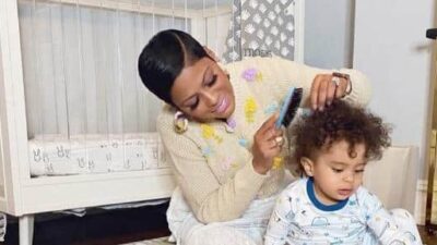 Tamron Hall combs her son Moses' hair / via Instagram